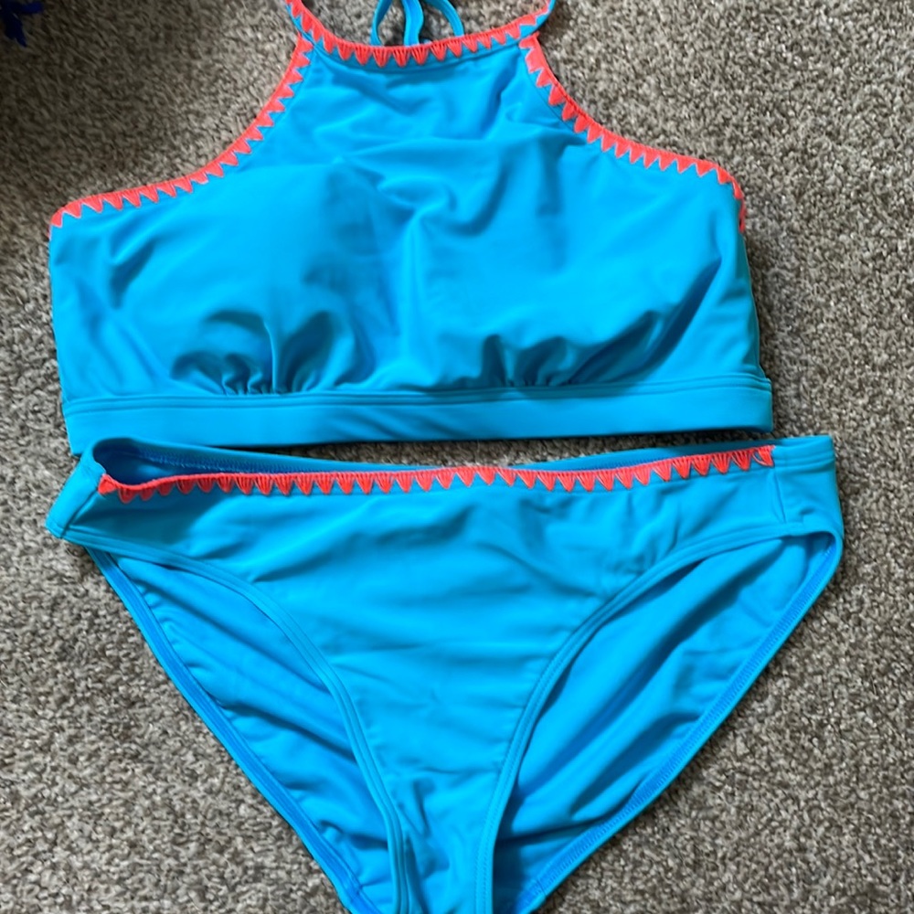Aqua with coral sewn around edges of top and bottom of both pieces.